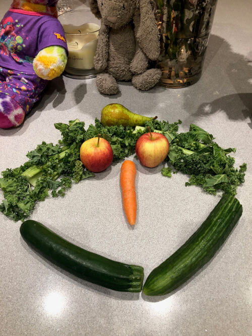 Picture of smiley face made out of fruit and vegetables